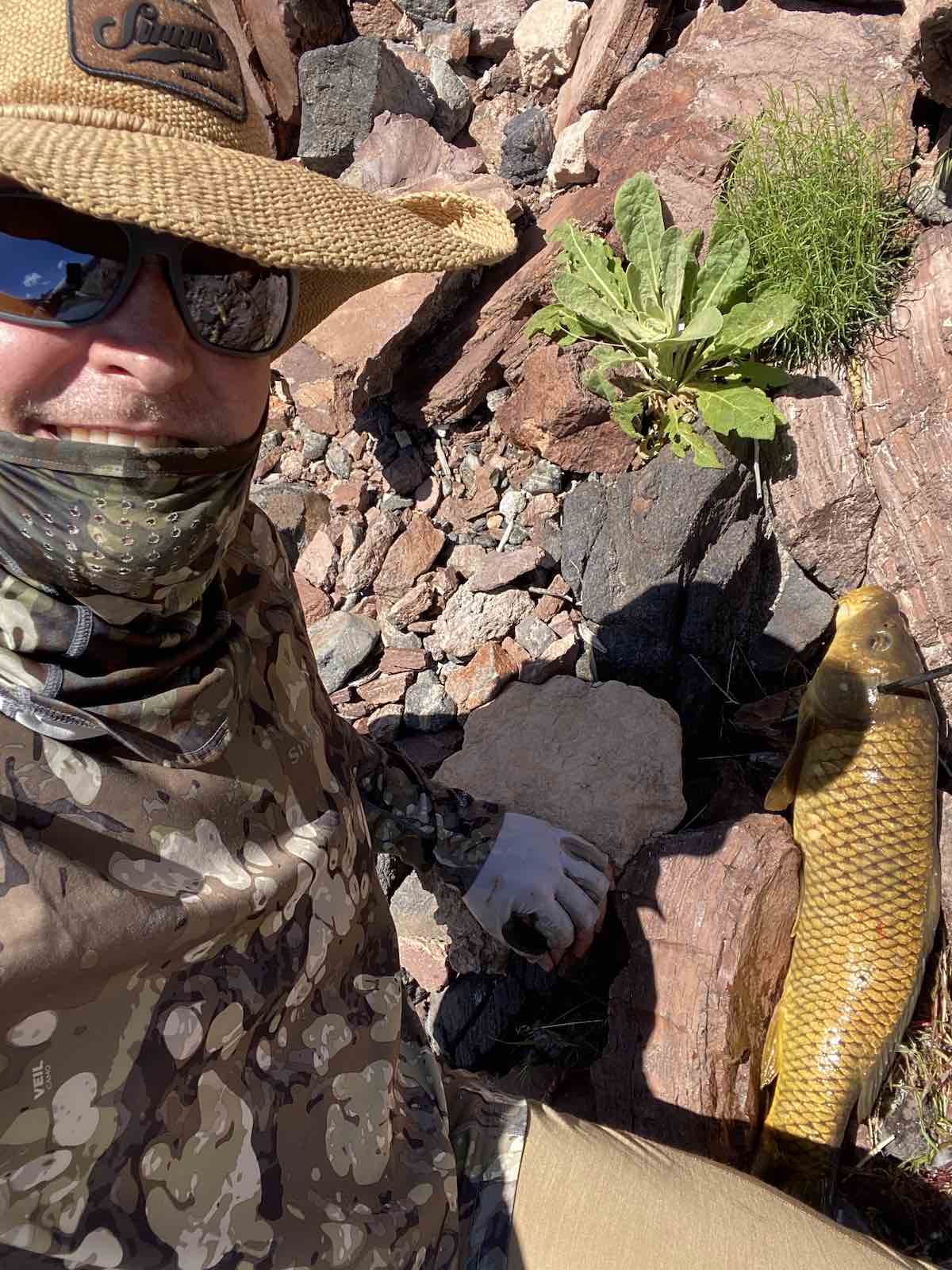 Posing with a carp shot while bowfishing